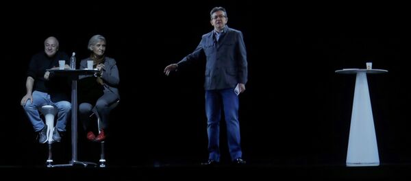 The hologram of politician Jean-Luc Melenchon (R), of the French far-left Parti de Gauche, and candidate for the 2017 French presidential election, speaks to supporters who are gathered in Saint-Denis, near Paris France, February 5, 2017 as Melenchon campaigns in Lyon - Sputnik International