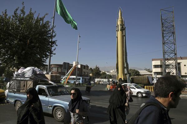 Iranians walk past a Ghadr-F missile displayed at a Revolutionary Guard hardware exhibition, marking 36th anniversary of the outset of Iran-Iraq war, at Baharestan Sq. in downtown Tehran, Iran (File) - Sputnik International