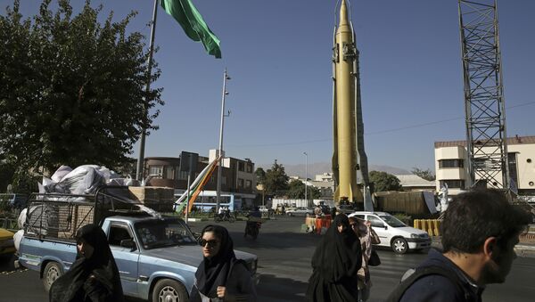 Iranians walk past a Ghadr-F missile displayed at a Revolutionary Guard hardware exhibition, marking 36th anniversary of the outset of Iran-Iraq war, at Baharestan Sq. in downtown Tehran, Iran (File) - Sputnik International