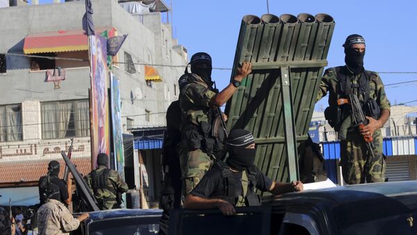 Palestinian militants from the al-Nasser Brigades, an armed wing of the Popular Resistance Committees (PRC), stand near rocket launcher while marching on their vehicles a long the streets during a rally to commemorate the 17th anniversary of their group in Rafah refugee camp, Gaza Strip, Monday, Sept. 26, 2016 - Sputnik International