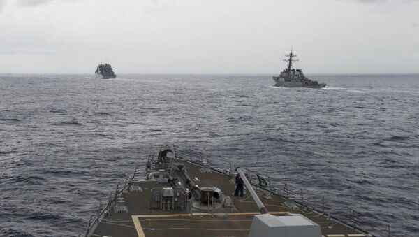 This image provided by the U.S. Navy, taken Oct. 17, 2016, shows the guided missile destroyer USS Decatur, right, pulling into position behind the Military Sealift Command USNS Matthew Perry, during a replenishment-at-sea, seen from the bridge of the guided-missile destroyer USS Spruance, in the South China Sea - Sputnik International
