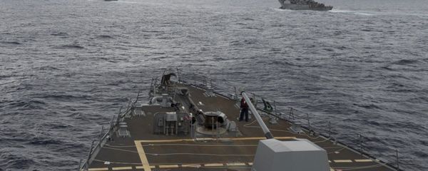 This image provided by the U.S. Navy, taken Oct. 17, 2016, shows the guided missile destroyer USS Decatur, right, pulling into position behind the Military Sealift Command USNS Matthew Perry, during a replenishment-at-sea, seen from the bridge of the guided-missile destroyer USS Spruance, in the South China Sea - Sputnik International