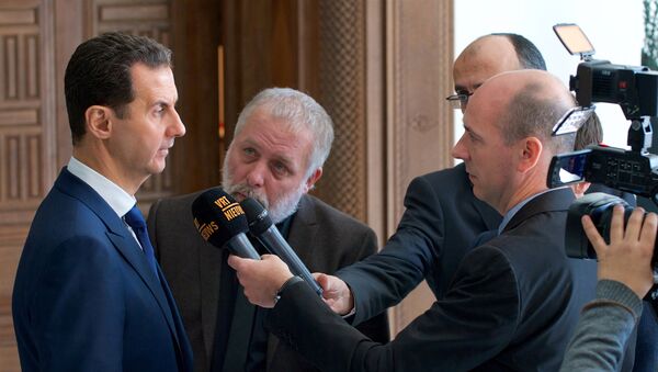 Syria's President Bashar al-Assad speaks to a group of Belgian reporters in this handout picture provided by SANA on February 7, 2017, Syria - Sputnik International