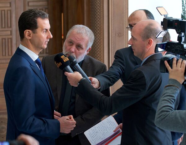 Syria's President Bashar al-Assad speaks to a group of Belgian reporters in this handout picture provided by SANA on February 7, 2017, Syria Syria's President Bashar al-Assad speaks to a group of Belgian reporters in this handout picture provided by SANA on February 7, 2017, Syria - Sputnik International