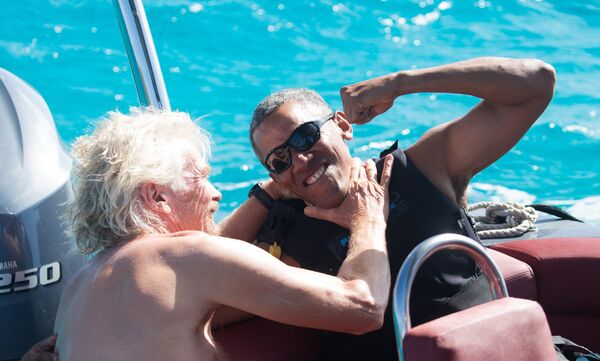 Former U.S. President Barack Obama and British businessman Richard Branson sit on a boat during Obama's holiday on Branson's Moskito island, in the British Virgin Islands - Sputnik International