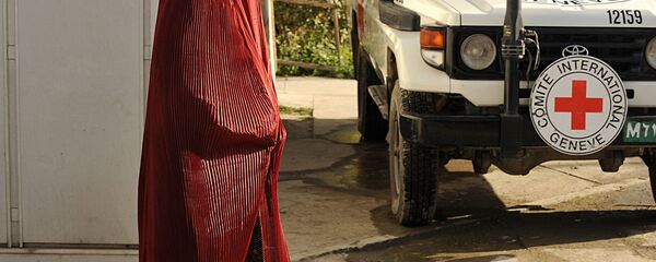 Afghan pedestrain walks past a vehicle at the International Committee for the Red Cross (ICRC) office in Kabul. (File) - Sputnik International