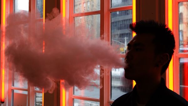 Man exhales vapor from an e-cigarette - Sputnik International