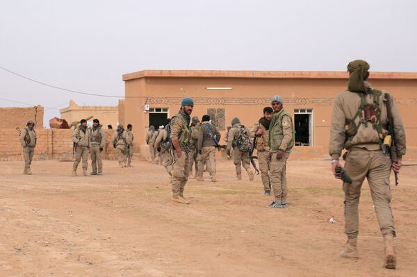 Syrian Democratic Forces (SDF) fighters walk with their weapons during an offensive against Daesh terrorists in northern Raqqa province, Syria Syrian Democratic Forces (SDF) fighters walk with their weapons during an offensive against Daesh terrorists in northern Raqqa province, Syria - Sputnik International