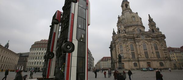 People walk next to the art instalation Monument by Syrian artist Manaf Halbouni, made from three passenger busses in Dresden, Germany February 8, 2017. - Sputnik International