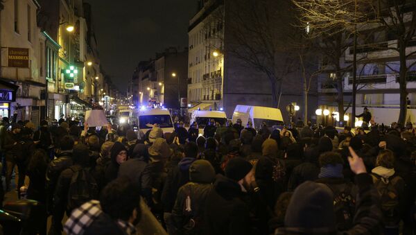 Police block a street as people gather to protest against an alleged police assault on a black man while in custody in central Paris - Sputnik International