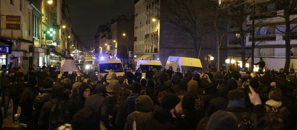 Police block a street as people gather to protest against an alleged police assault on a black man while in custody in central Paris Police block a street as people gather to protest against an alleged police assault on a black man while in custody in central Paris - Sputnik International