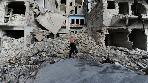 A man walks near damaged buildings in Aleppo, Syria January 30, 2017. - Sputnik International
