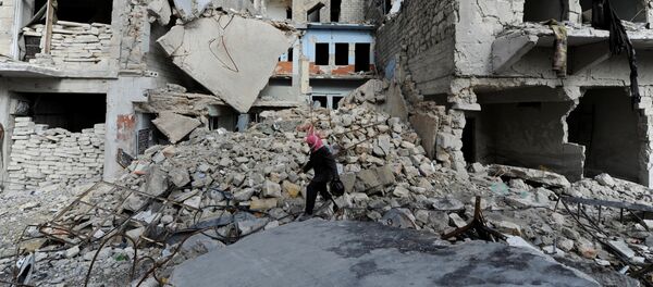 A man walks near damaged buildings in Aleppo, Syria January 30, 2017. - Sputnik International