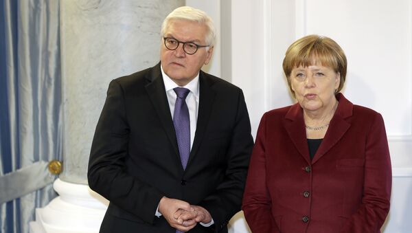 German Chancellor Angela Merkel, right, and German Foreign Minister Frank-Walter Steinmeier, left, talk as they pose for the media during a New Year's reception of German President Joachim Gauck at the Bellevue palace in Berlin, Germany, Tuesday, January 10, 2017. - Sputnik International