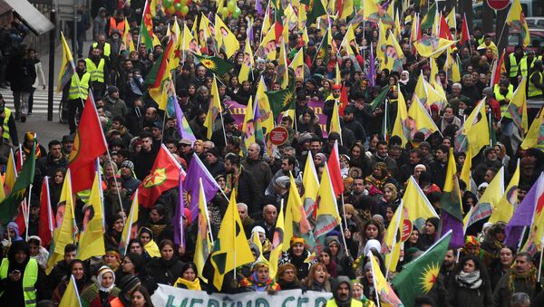 Kurds wave flags and banners of convicted Kurdistan Worker's Party (PKK) leader Abdullah Ocalan during a demonstration by several thousand people from all around Europe asking for Ocalan's release in Strasbourg, eastern France - Sputnik International