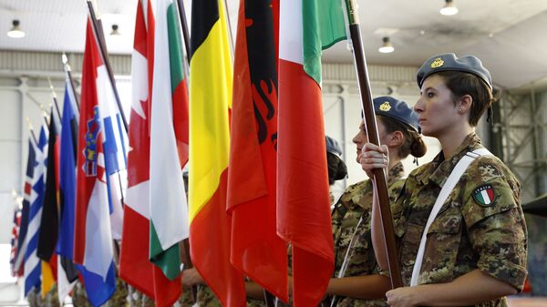 Soldiers line up holding flags of NATO member countries, during the opening ceremony of NATO Trident Juncture exercise 2015, in Trapani, Italy, Monday, Oct. 19, 2015 - Sputnik International