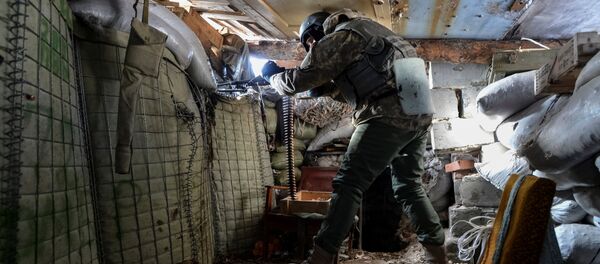 A Ukrainian serviceman holds a weapon at a position on the front line near the government-held town of Avdiyivka, Ukraine, February 10, 2017 - Sputnik International