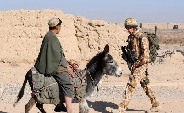 A photograph made available February 28, 2008, shows Britain's Prince Harry (R) as he passes a donkey while on patrol through the deserted town of Garmisir close to FOB Delhi (forward operating base), in Helmand province in Southern Afghanistan, on January 02, 2008 - Sputnik International