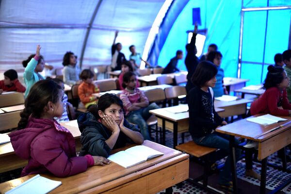 Syrian children take lessons in a makeshift school tent in a refugee camp in the town of Suruc, Sanliurfa province (File) Syrian children take lessons in a makeshift school tent in a refugee camp in the town of Suruc, Sanliurfa province (File) - Sputnik International