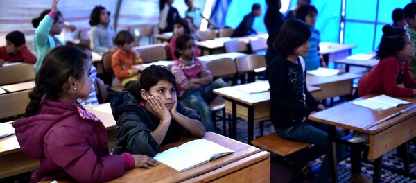 Syrian children take lessons on November 10, 2014 in a makeshift school tent in a refugee camp in the town of Suruc, Sanliurfa province (File) Syrian children take lessons on November 10, 2014 in a makeshift school tent in a refugee camp in the town of Suruc, Sanliurfa province (File) - Sputnik International