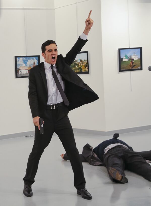 In this Monday, Dec. 19, 2016 file photo, Mevlut Mert Altintas shouts after shooting Andrei Karlov, right, the Russian ambassador to Turkey, at an art gallery in Ankara, Turkey In this Monday, Dec. 19, 2016 file photo, Mevlut Mert Altintas shouts after shooting Andrei Karlov, right, the Russian ambassador to Turkey, at an art gallery in Ankara, Turkey - Sputnik International