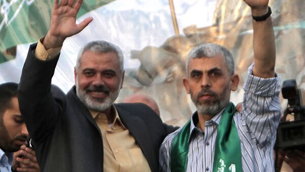 This file photo taken on October 21, 2011 shows then Hamas leader Ismail Haniya (L) and freed Palestinian prisoner Yahya Sinwar (R), a founder of Hamas' military wing, waving as supporters celebrate the release of hundreds of prisoners following a swap with captured Israeli soldier Gilad Shalit in Khan Yunis, southern Gaza Strip - Sputnik International