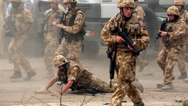 In this May 6 , 2006 file photo, a British trooper falls after apparently being hit by a rock, as British troops move towards a helicopter crash site in Basra, Iraq's second-largest city, 550 kilometers (340 miles) southeast of Baghdad. Britain’s prime minister announced plans on Oct. 4, 2016 to protect British troops from dubious legal claims made during conflicts. - Sputnik International
