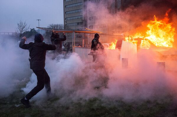 A car is ablaze in the Paris suburb of Bobigny during a protest against police brutality. file photo - Sputnik International
