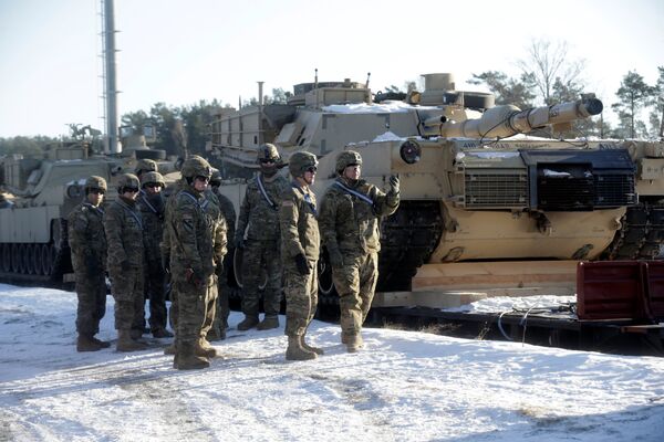 U.S. soldiers stand next to the M1 Abrams tanks that will be deployed in Latvia for NATO's Operation Atlantic Resolve in Garkalne, Latvia February 8, 2017 U.S. soldiers stand next to the M1 Abrams tanks that will be deployed in Latvia for NATO's Operation Atlantic Resolve in Garkalne, Latvia February 8, 2017 - Sputnik International