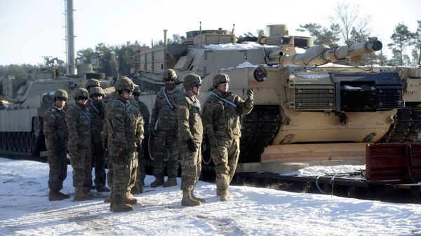U.S. soldiers stand next to the M1 Abrams tanks that will be deployed in Latvia for NATO's Operation Atlantic Resolve in Garkalne, Latvia February 8, 2017 - Sputnik International