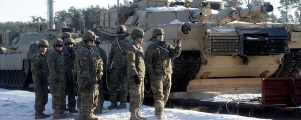 U.S. soldiers stand next to the M1 Abrams tanks that will be deployed in Latvia for NATO's Operation Atlantic Resolve in Garkalne, Latvia February 8, 2017 - Sputnik International