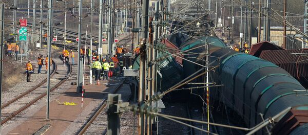 Rescuers stand next the wreckage of a passenger and freight train after a crash near Bettembourg, Luxembourg February 14, 2017 - Sputnik International
