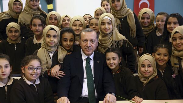 Turkey's President Recep Tayyip Erdogan poses for a photo with students of a religious girl school in Istanbul, Saturday, Dec. 10, 2016. - Sputnik International
