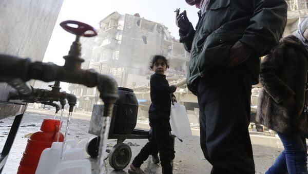 This file photo taken on January 21, 2017 shows Syrians standing next to water faucets as they fill jerrycans in Aleppo's formerly rebel-held al-Shaar neighbourhood, a month after government forces retook the northern Syrian city from rebel fighters - Sputnik International
