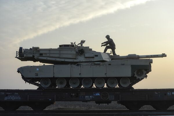 A serviceman of the Fighting Eagles 1st Battalion, 8th Infantry Regiment, walks on a tank that arrived via train to the US base in Mihail Kogalniceanu, eastern Romania, Tuesday, Feb. 14, 2017. Five hundred U.S. troops began to arrive in a Black Sea port in Romania with tanks and hardware to bolster defense in this East European NATO nation. A serviceman of the Fighting Eagles 1st Battalion, 8th Infantry Regiment, walks on a tank that arrived via train to the US base in Mihail Kogalniceanu, eastern Romania, Tuesday, Feb. 14, 2017. Five hundred U.S. troops began to arrive in a Black Sea port in Romania with tanks and hardware to bolster defense in this East European NATO nation. - Sputnik International
