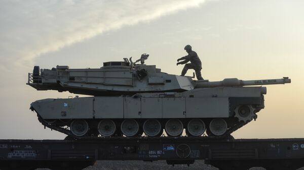A serviceman of the Fighting Eagles 1st Battalion, 8th Infantry Regiment, walks on a tank that arrived via train to the US base in Mihail Kogalniceanu, eastern Romania, Tuesday, Feb. 14, 2017. Five hundred U.S. troops began to arrive in a Black Sea port in Romania with tanks and hardware to bolster defense in this East European NATO nation. - Sputnik International