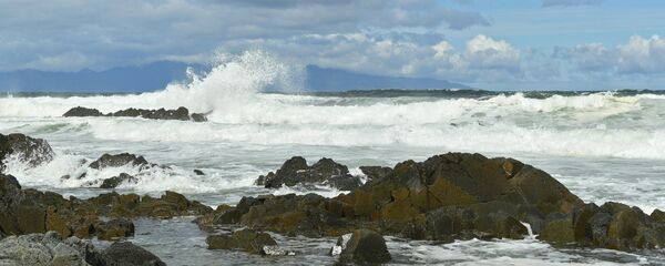 The coast of the Sea of Okhotsk near Cape Stolbchaty in the west of Kunashir Island of the Greater Kuril Ridge. Japan's Hokkaido Island at the background The coast of the Sea of Okhotsk near Cape Stolbchaty in the west of Kunashir Island of the Greater Kuril Ridge. Japan's Hokkaido Island at the background - Sputnik International