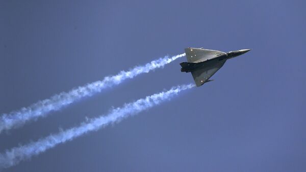 Indian Air Force indigenous Tejas Light Combat Aircraft displays its maneuverability during Air Force day parade at the Hindon air base on the outskirts of New Delhi, India, Saturday, Oct. 8, 2016 - Sputnik International
