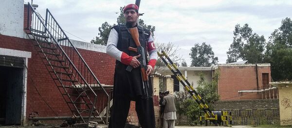 A Pakistani security officer stands alert at the site of a bombing in Ghalanai in the Pakistan's tribal region of Mohmand, Wednesday, Feb. 15, 2017 - Sputnik International