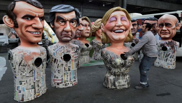 Giant figures of (L-R) Emmanuel Macron, head of the political movement En Marche !, or Onwards !, and candidate for the 2017 presidential election, Francois Fillon, former French prime minister, member of The Republicans political party and 2017 presidential candidate of the French centre-right, and French National Front leader Marine Le Pen, are seen during preparations for the carnival parade in Nice, France, February 2, 2017 - Sputnik International