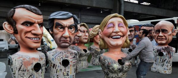 Giant figures of (L-R) Emmanuel Macron, head of the political movement En Marche !, or Onwards !, and candidate for the 2017 presidential election, Francois Fillon, former French prime minister, member of The Republicans political party and 2017 presidential candidate of the French centre-right, and French National Front leader Marine Le Pen, are seen during preparations for the carnival parade in Nice, France, February 2, 2017 Giant figures of (L-R) Emmanuel Macron, head of the political movement En Marche !, or Onwards !, and candidate for the 2017 presidential election, Francois Fillon, former French prime minister, member of The Republicans political party and 2017 presidential candidate of the French centre-right, and French National Front leader Marine Le Pen, are seen during preparations for the carnival parade in Nice, France, February 2, 2017 - Sputnik International