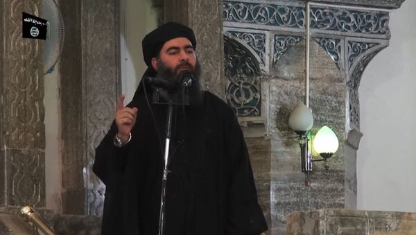 This July 5, 2014 photo shows an image grab taken from a propaganda video released by al-Furqan Media allegedly showing Daesh leader Abu Bakr al-Baghdadi, aka Caliph Ibrahim, adressing Muslim worshippers at a mosque in the militant-held northern Iraqi city of Mosul - Sputnik International