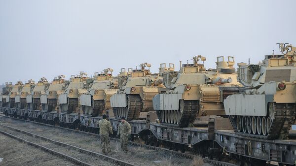 Servicemen of the Fighting Eagles 1st Battalion, 8th Infantry Regiment, walk by tanks that arrived via train to the US base in Mihail Kogalniceanu, eastern Romania, Tuesday, Feb. 14, 2017. - Sputnik International