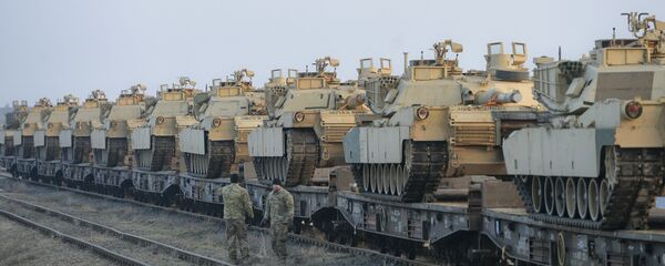 Servicemen of the Fighting Eagles 1st Battalion, 8th Infantry Regiment, walk by tanks that arrived via train to the US base in Mihail Kogalniceanu, eastern Romania, Tuesday, Feb. 14, 2017. Servicemen of the Fighting Eagles 1st Battalion, 8th Infantry Regiment, walk by tanks that arrived via train to the US base in Mihail Kogalniceanu, eastern Romania, Tuesday, Feb. 14, 2017. - Sputnik International