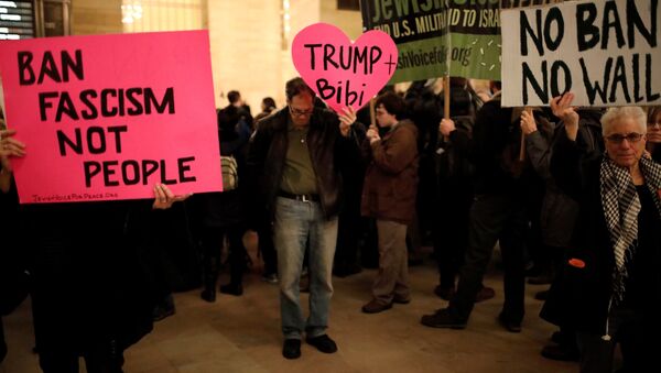 Demonstrators hold signs during a Muslim and Jewish Solidarity protest against the policies of U.S. President Donald Trump and Israeli Prime Minister Benjamin Netanyahu at Grand Central Terminal in New York City, U.S. - Sputnik International