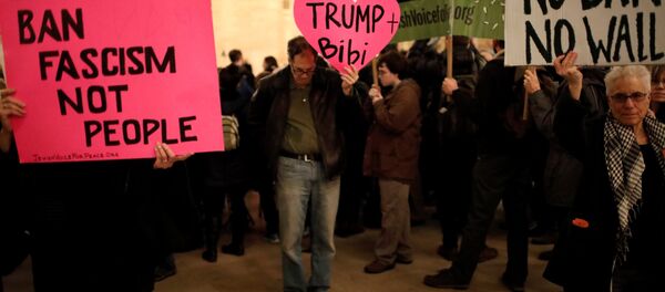 Demonstrators hold signs during a Muslim and Jewish Solidarity protest against the policies of U.S. President Donald Trump and Israeli Prime Minister Benjamin Netanyahu at Grand Central Terminal in New York City, U.S. Demonstrators hold signs during a Muslim and Jewish Solidarity protest against the policies of U.S. President Donald Trump and Israeli Prime Minister Benjamin Netanyahu at Grand Central Terminal in New York City, U.S. - Sputnik International