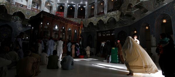 A woman clad in burqa walks in the hallway of the tomb of Sufi saint Syed Usman Marwandi, also known as Lal Shahbaz Qalandar, in Sehwan Sharif, in Pakistan's southern Sindh province. (File) - Sputnik International