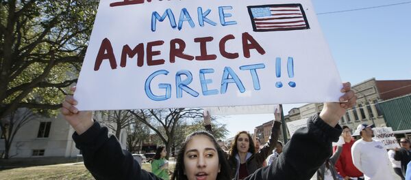 A protester holds a sign during a Day Without Immigrants Protest in Texas A protester holds a sign during a Day Without Immigrants Protest in Texas - Sputnik International