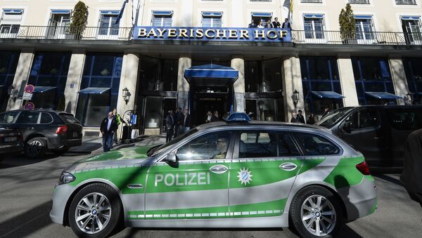 A police car passes the Bayerischer Hof hotel in Munich, southern Germany, on February 16, 2017. The Bayerischer Hof hotel will be the location for the 53rd Munich Security Conference (MSC) from February 17-19, 2017. - Sputnik International