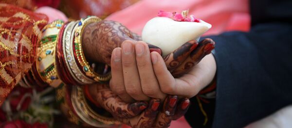 An Indian couple prepares to take part in a mass wedding in Ahmedabad An Indian couple prepares to take part in a mass wedding in Ahmedabad - Sputnik International